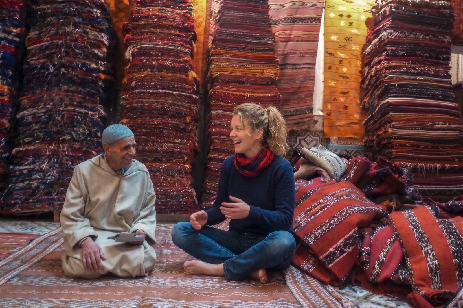 Checking handwoven Moroccan rugs in a rug shop