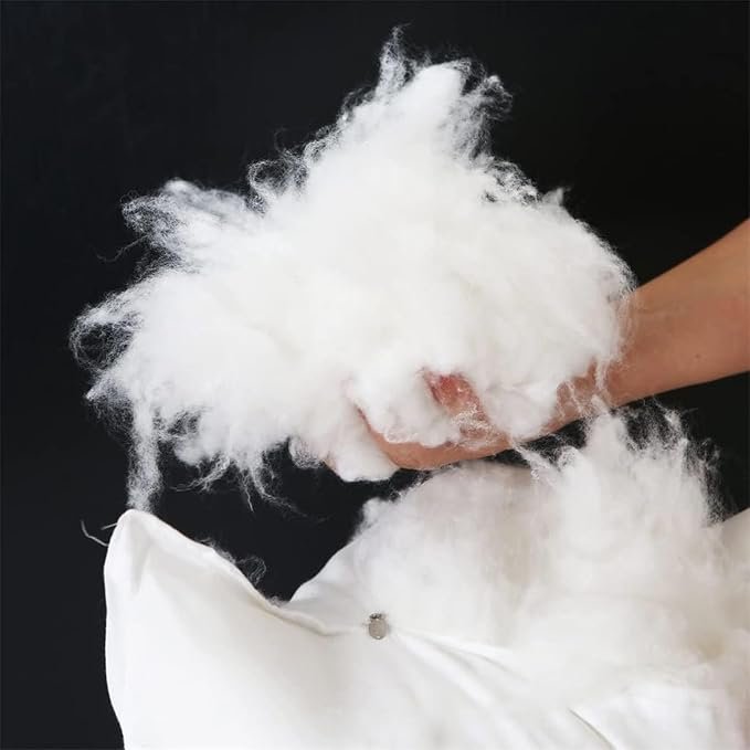 Polyester fiberfill being pushed into a cushion cover